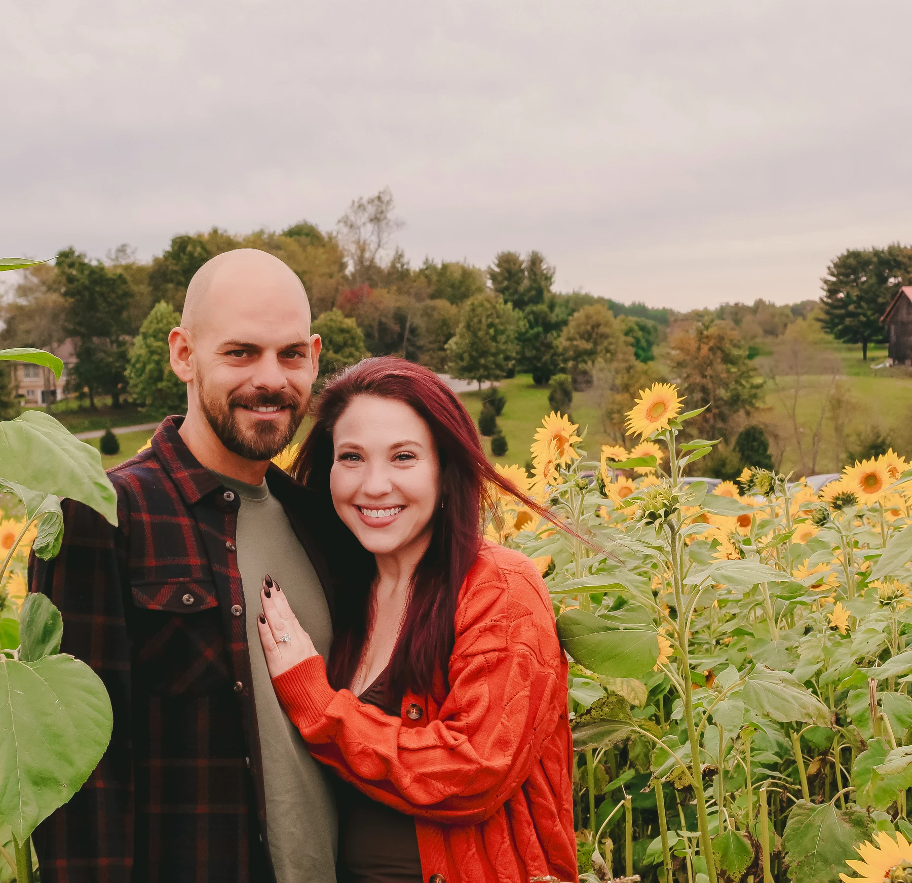 Smiling couple together in a sunflower field