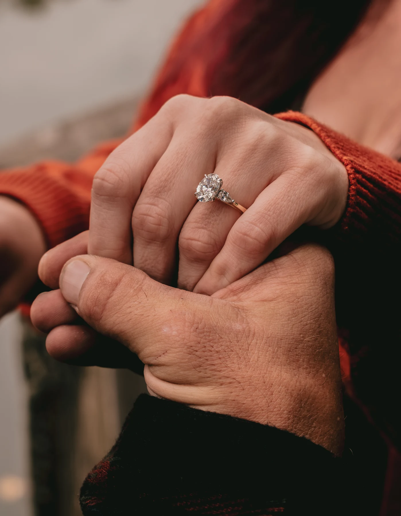 Close-up of the engagement ring as the couple gently holds hands