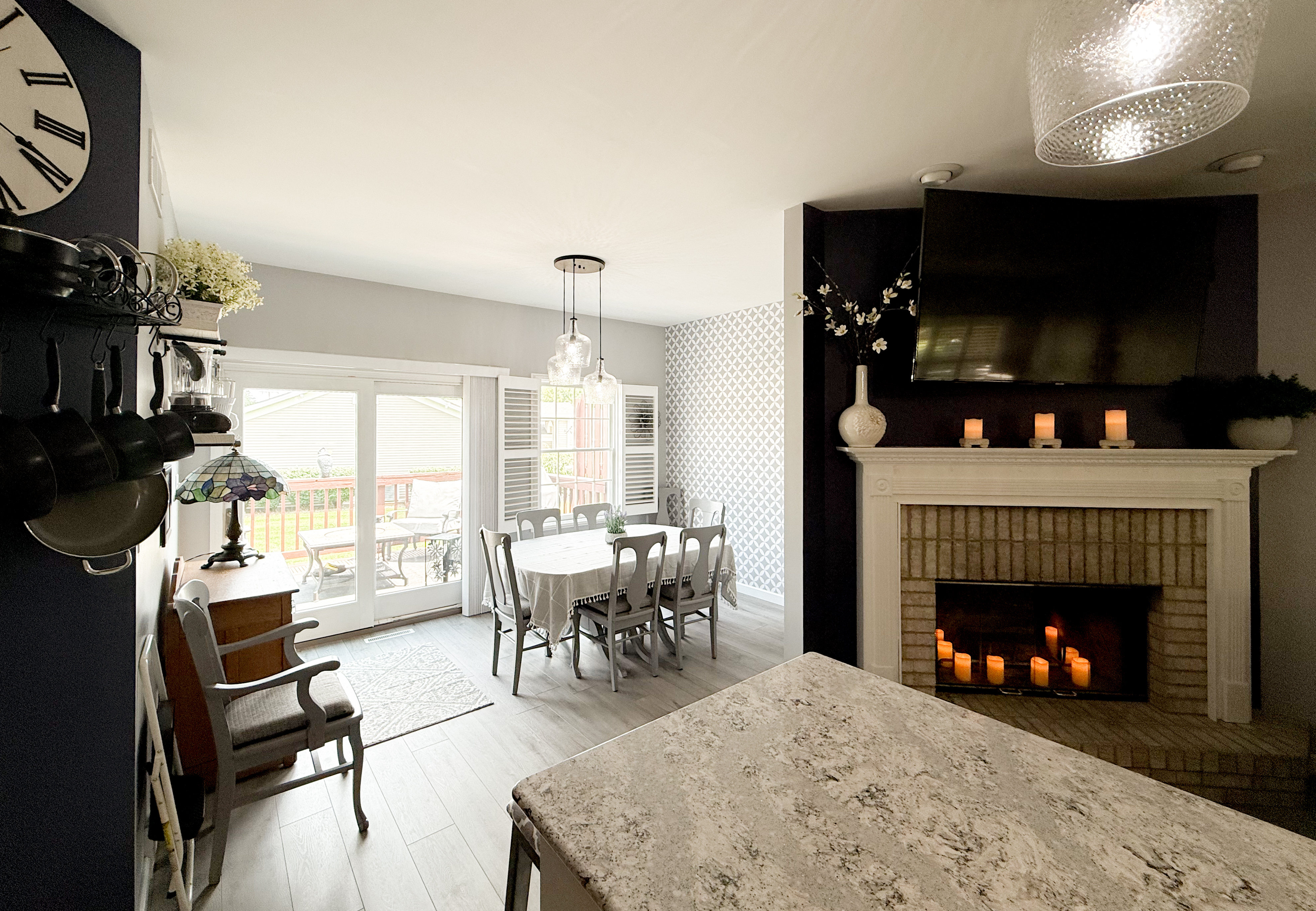 Living and dining space with fireplace, listing photography