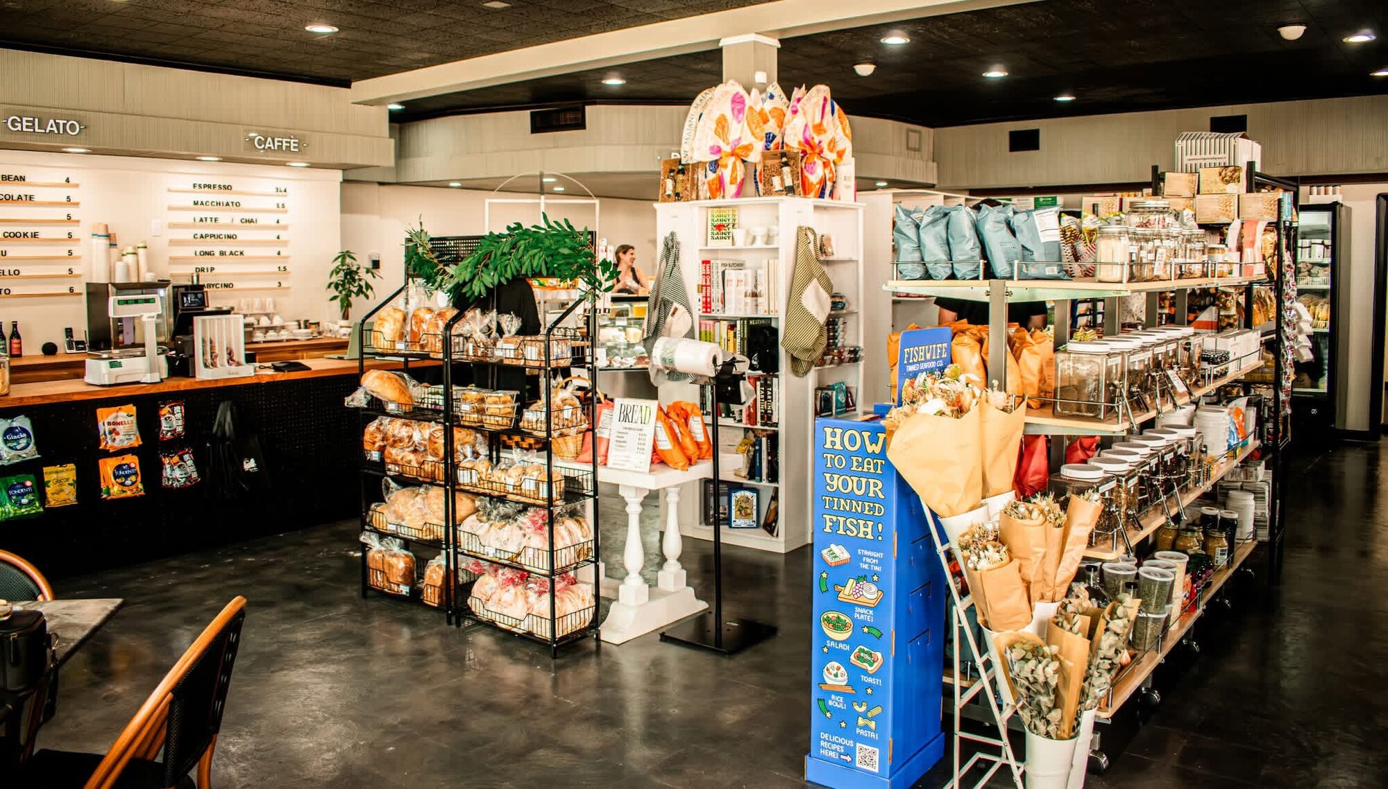 Wide view of the specialty grocery interior with merchandised displays