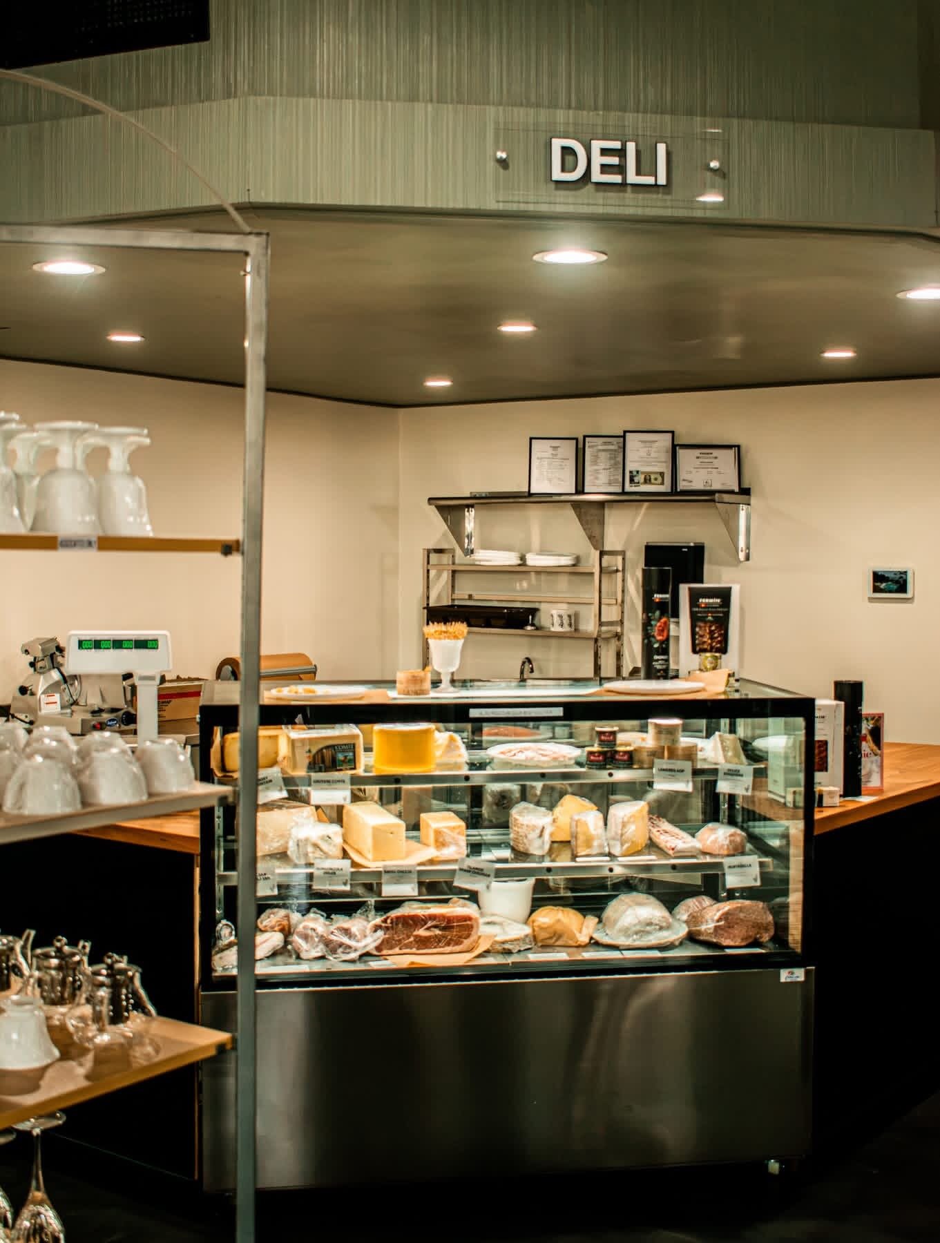 Deli counter with a glass case of cheeses and cured meats