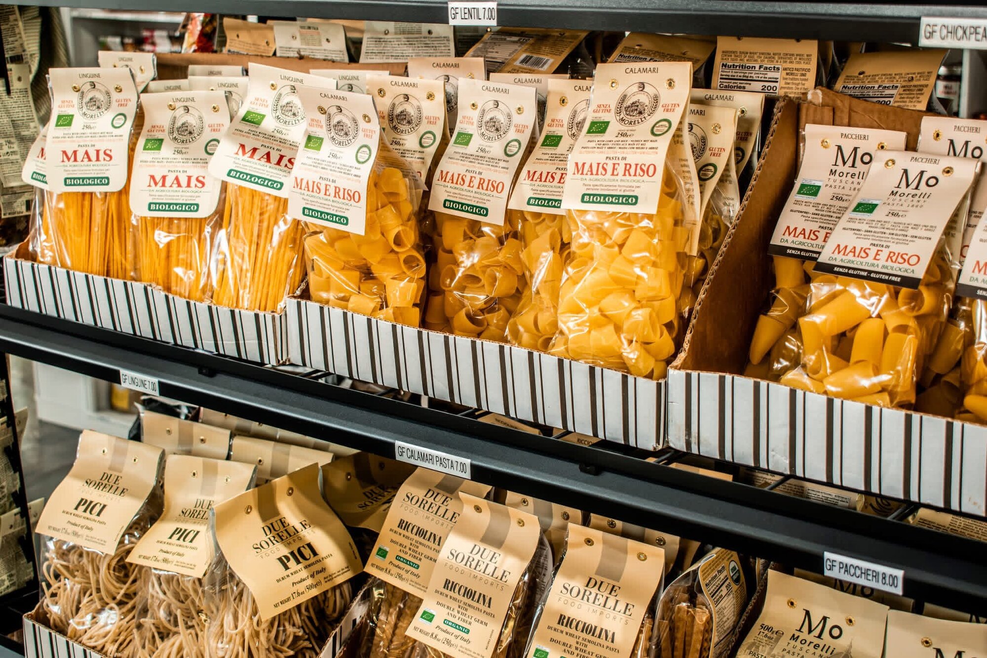 Shelves of imported Italian pasta in paper and cellophane packaging