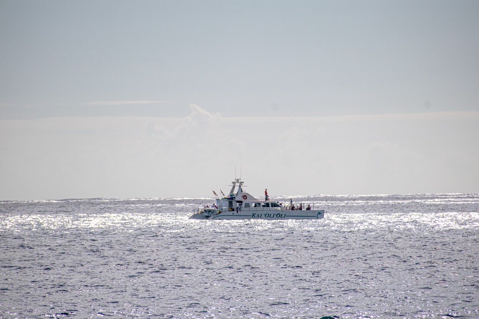 Navy ship on sparkling silver ocean water
