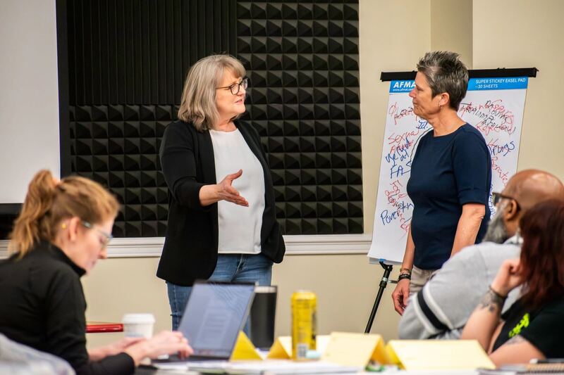 Facilitators leading a discussion with flip charts at a workshop