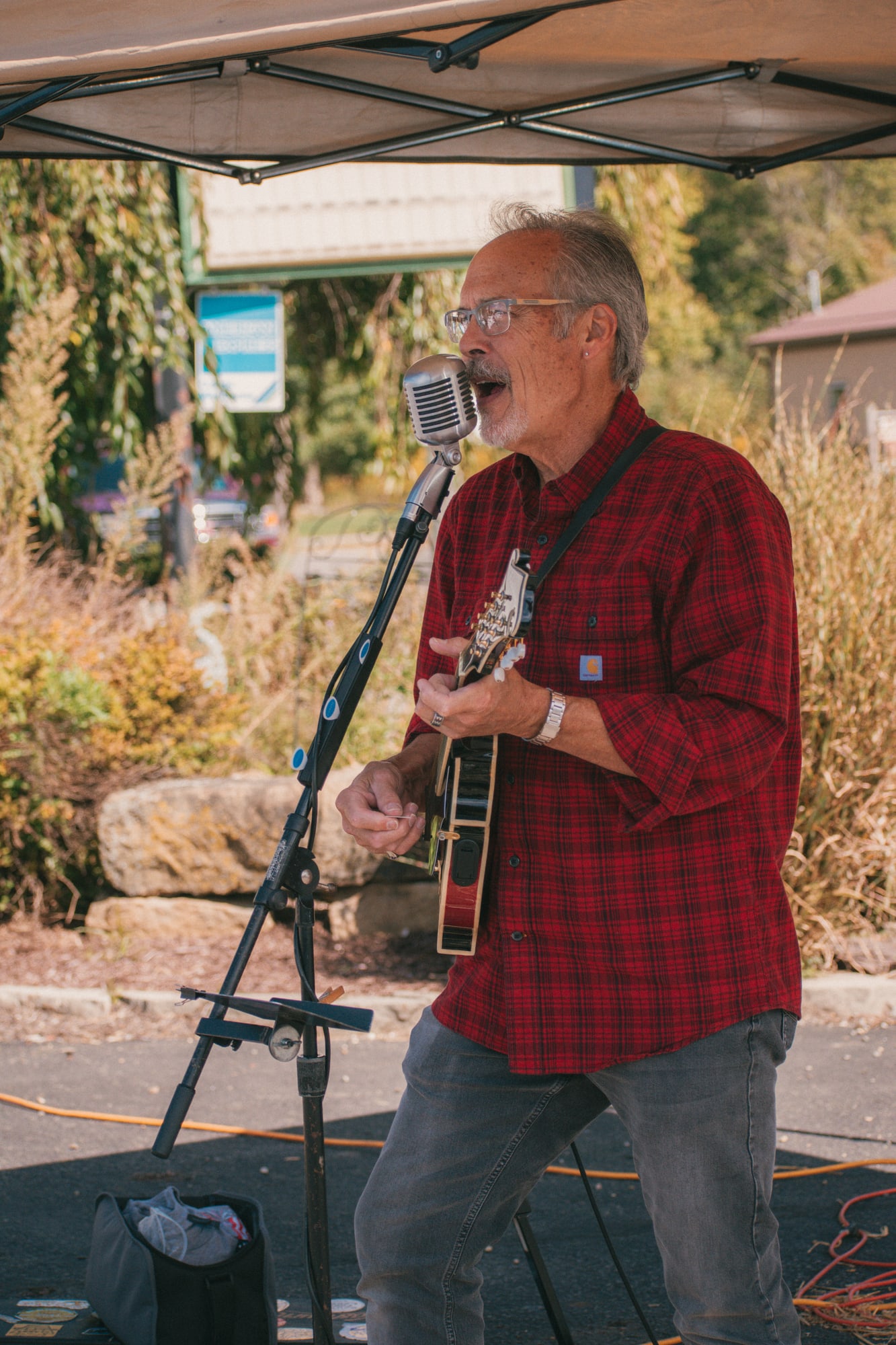 Live singer and guitarist performing at Grove City Agway 2026 Petfest