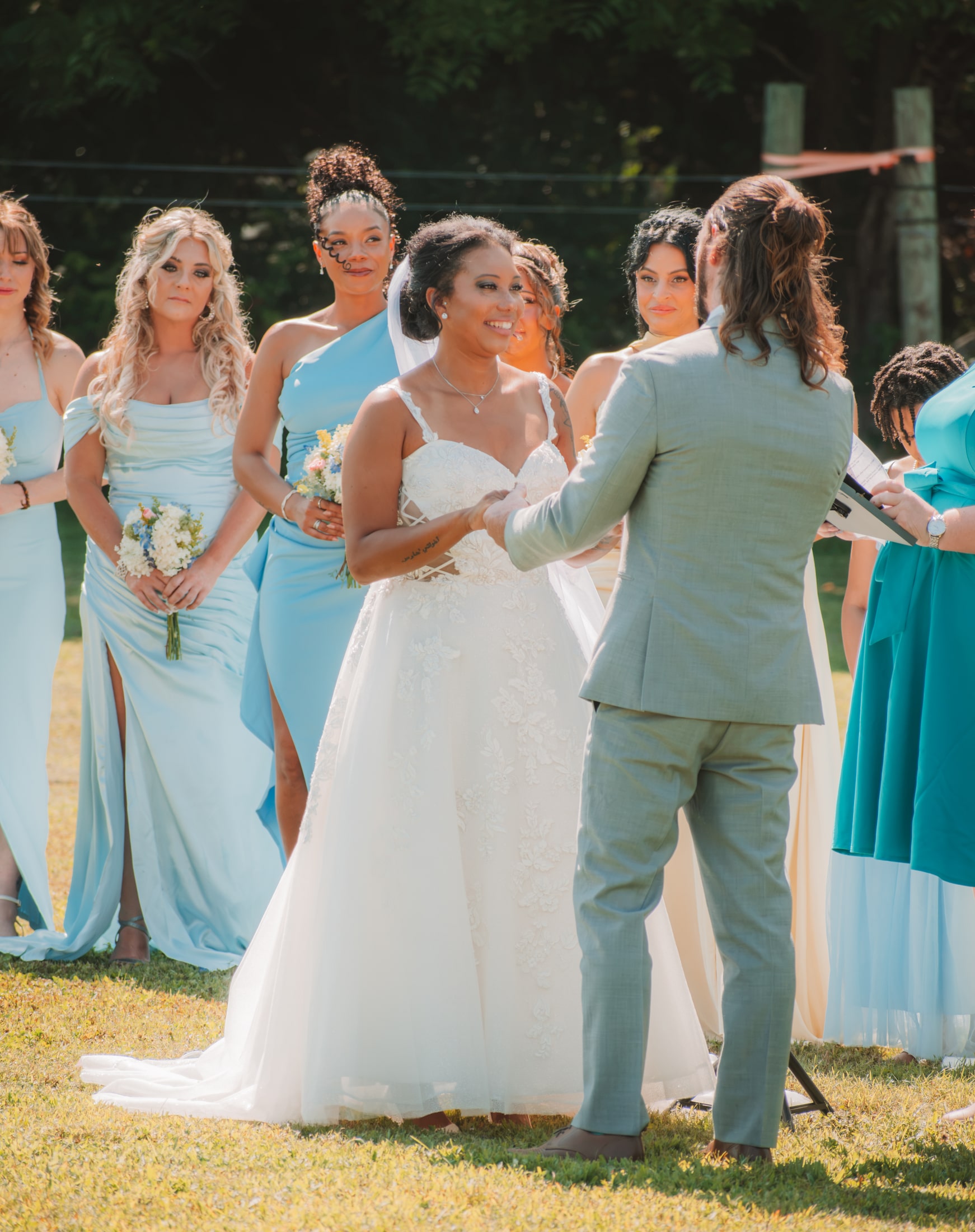 Joyful bride celebrating with adult members of the wedding party after the ceremony