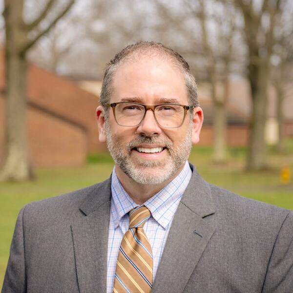 Professional corporate headshot, natural light
