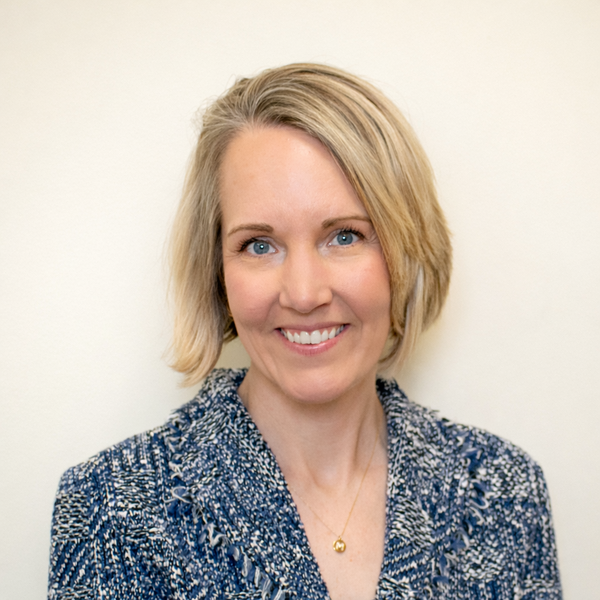 Professional staff headshot with soft natural backdrop